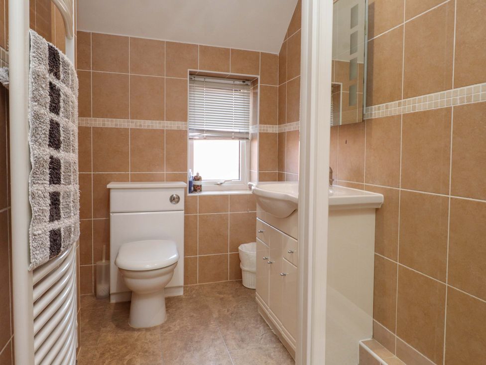 A bathroom with a toilet and sink at The Old Stables in Rhos-On-Sea