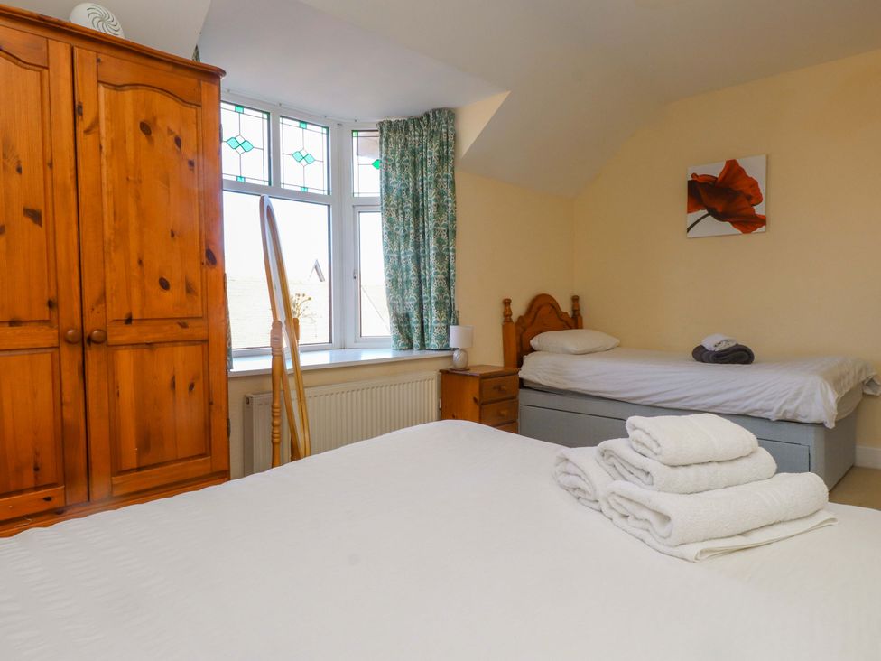 A bedroom with a double bed and a single bed at The Old Stables Rhos-On-Sea