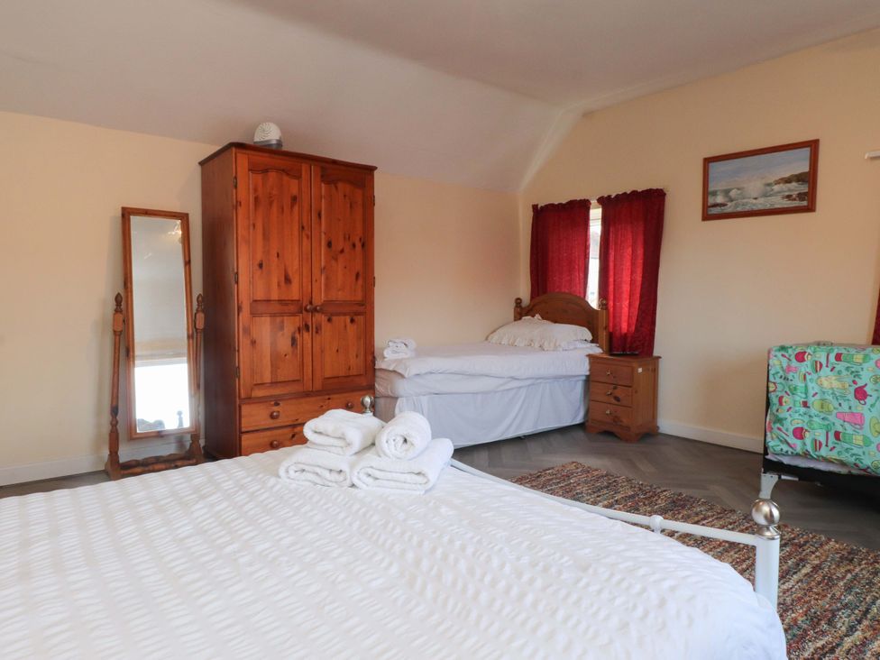 A bedroom with a double bed and a single bed at The Old Stables in Rhos-On-Sea