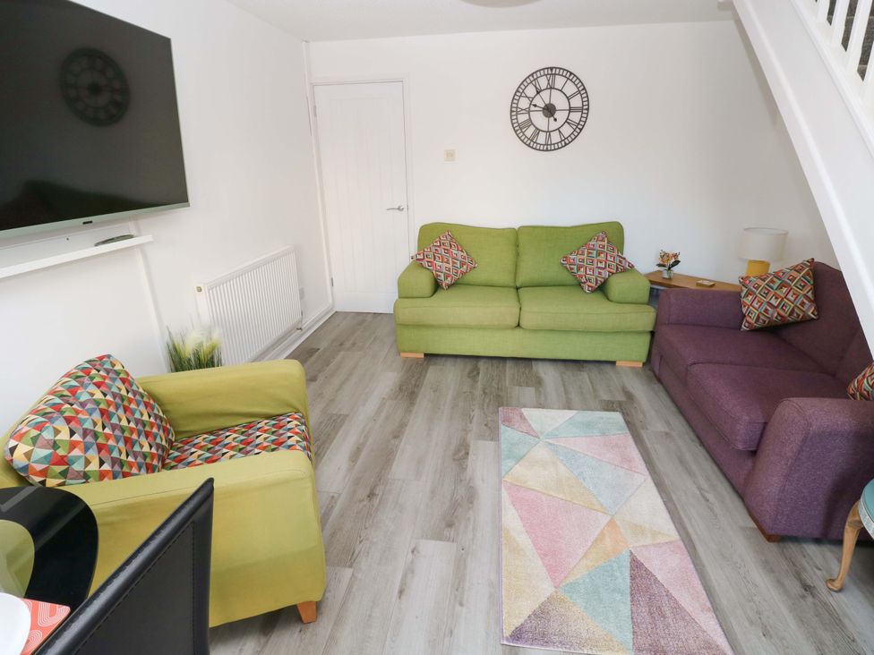 A living room with sofa and armchair at The Gower Gateway in Gowerton near Swansea