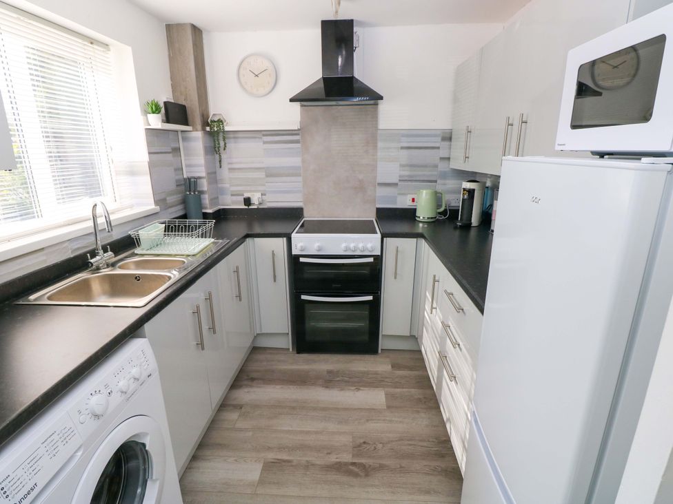 A kitchen with a sink and oven at The Gower Gateway in Gowerton near Swansea