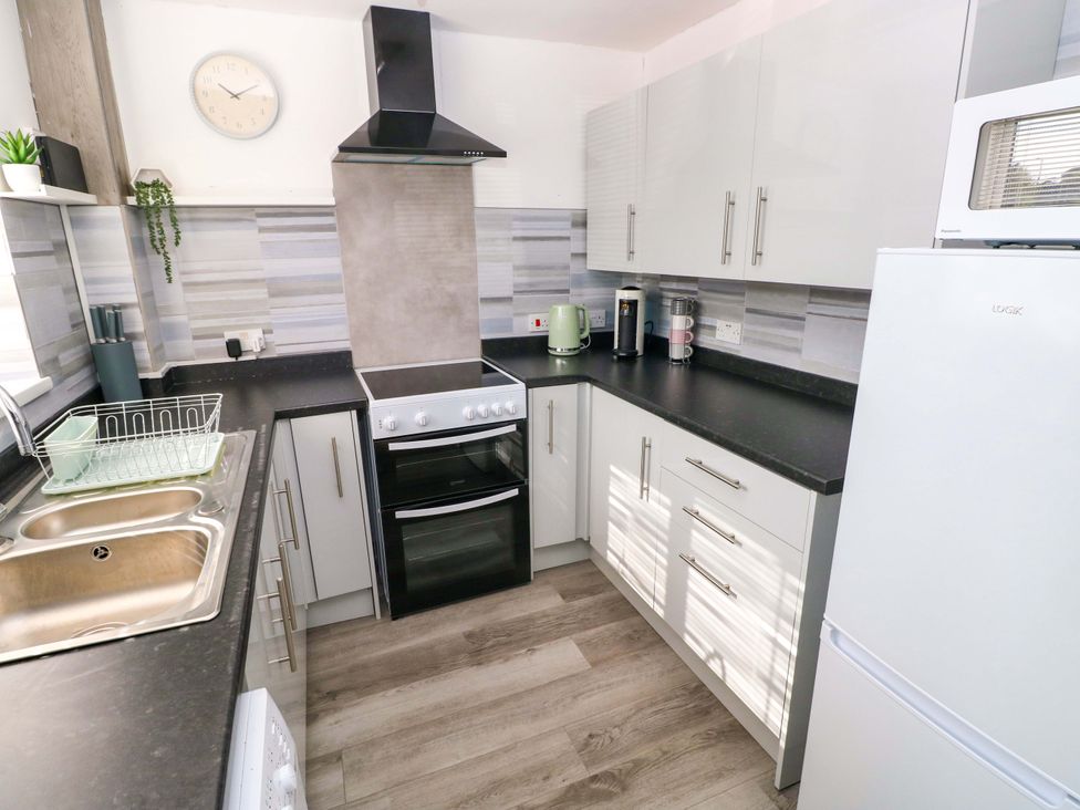 A kitchen with appliances and sink at The Gower Gateway in Gowerton near Swansea