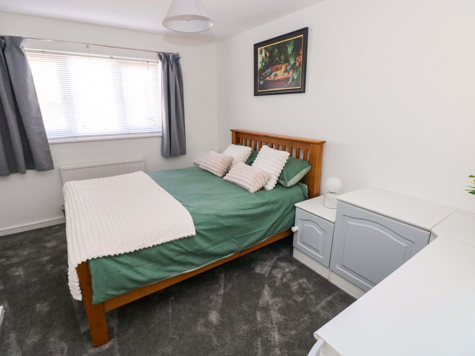 A bedroom with a bed and window at The Gower Gateway in Gowerton near Swansea