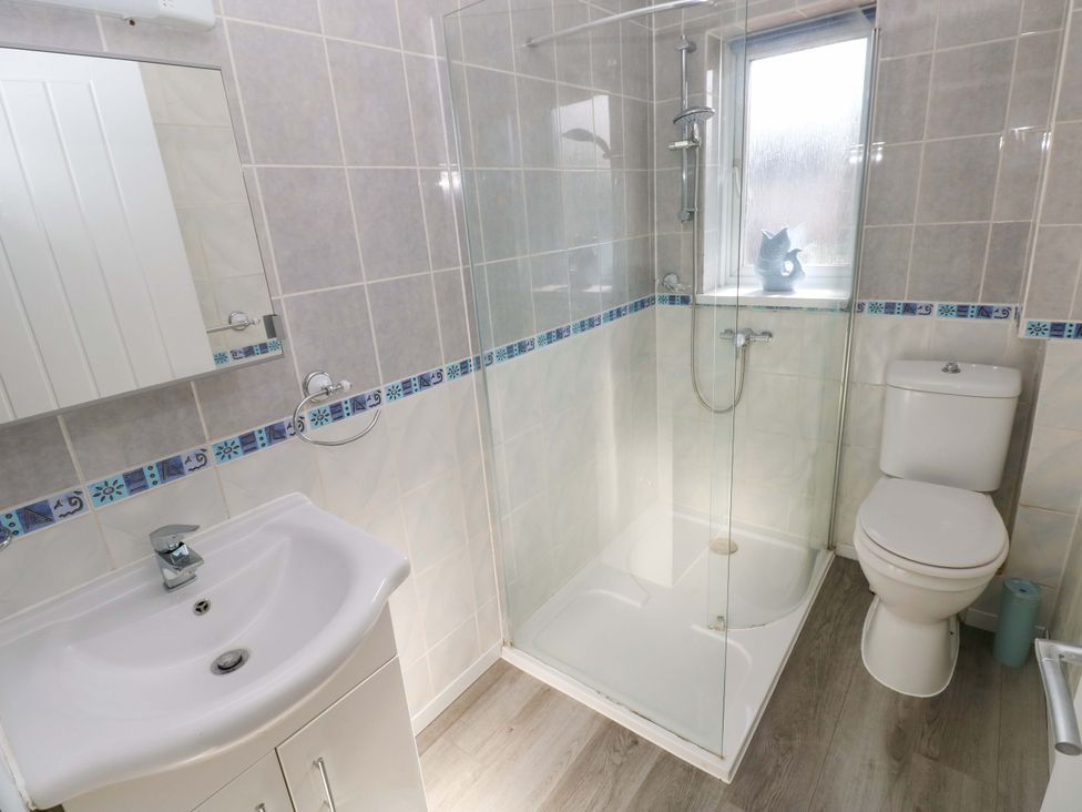 A bathroom with a shower and sink at The Gower Gateway in Gowerton near Swansea