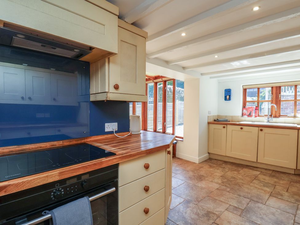 A kitchen with cabinets and appliances at Fleming Cottage