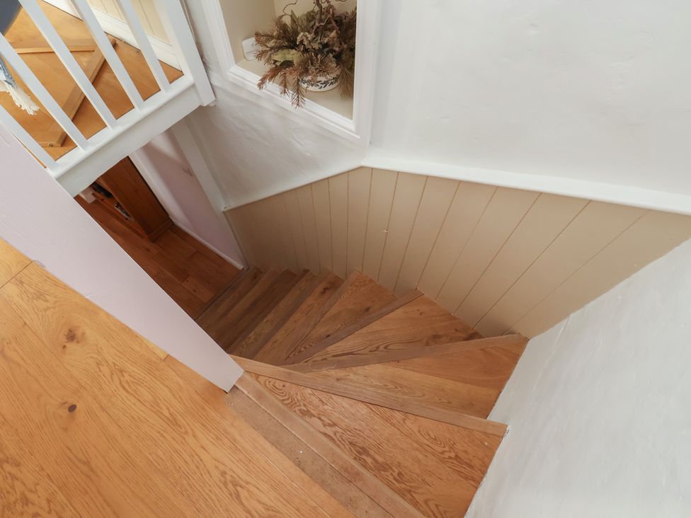 A staircase with wooden steps and a railing at Fleming Cottage 