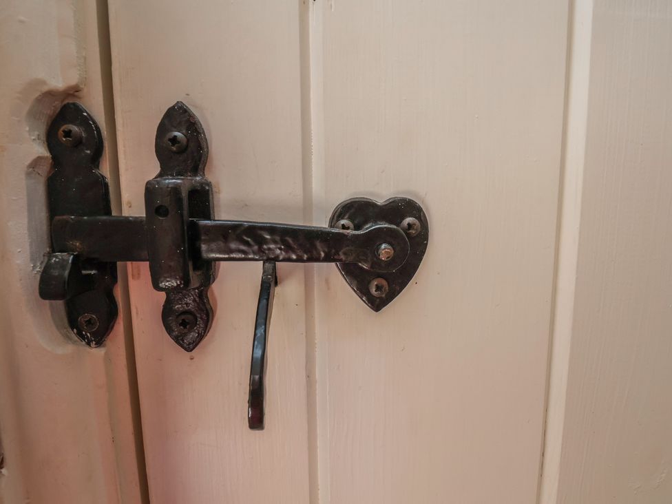 A door latch with a heart-shaped design at Fleming Cottage