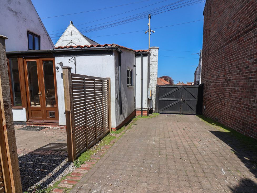 An outdoor area with a house, gate, and pathway at Fleming Cottage in 
