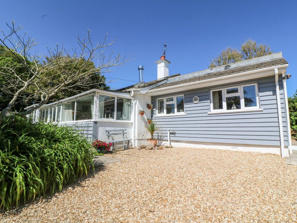 An outdoor view of a house with a gravel area and plants at Tinners Way Helston