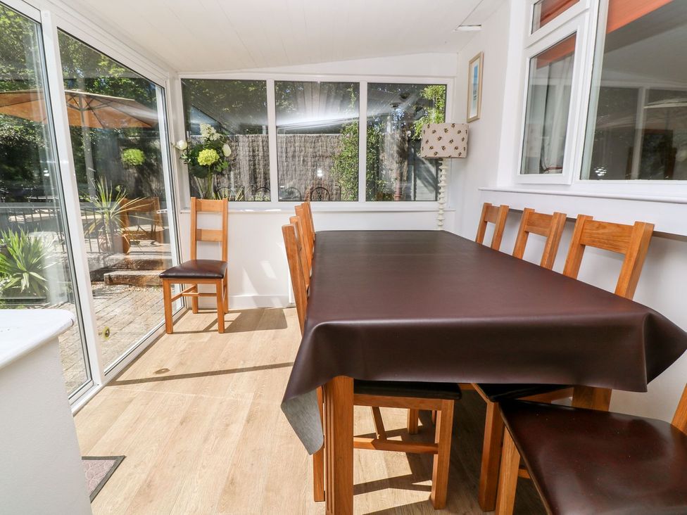A dining area with a table and chairs at Tinners Way Helston