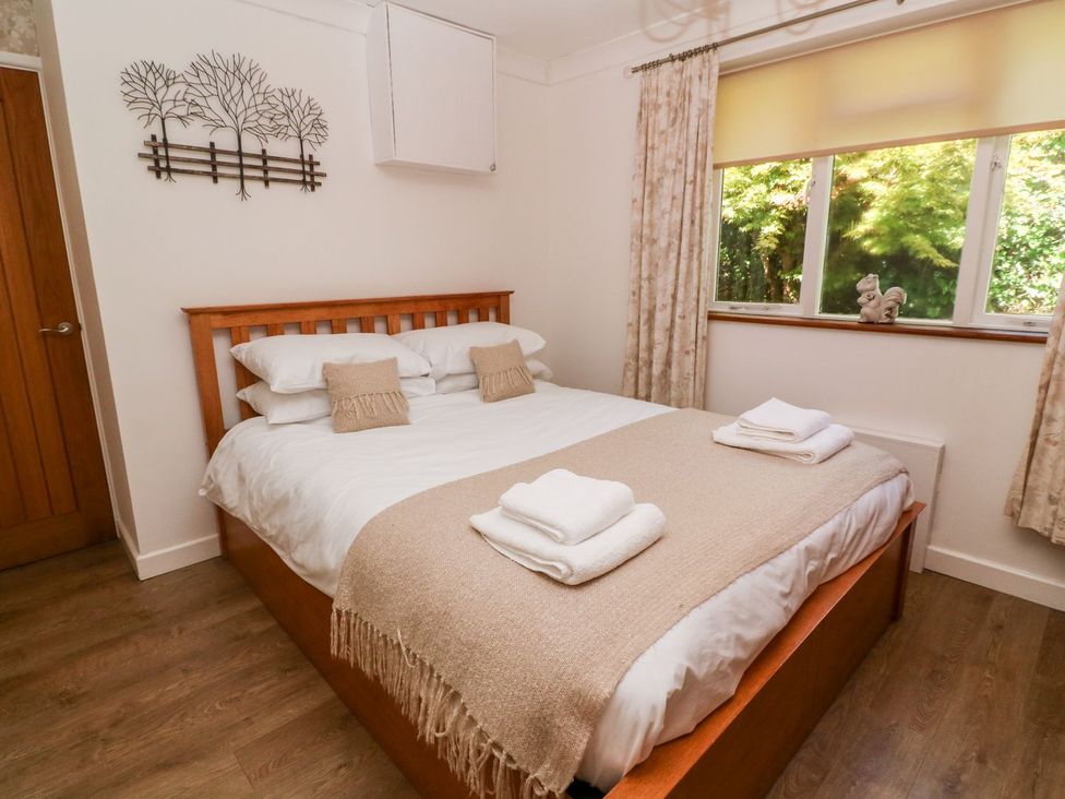 A bedroom with a bed and pillows at Tinners Way in Helston