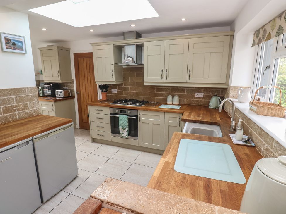 A kitchen with appliances and wood countertops at Tinners Way Tresowes near Ashton