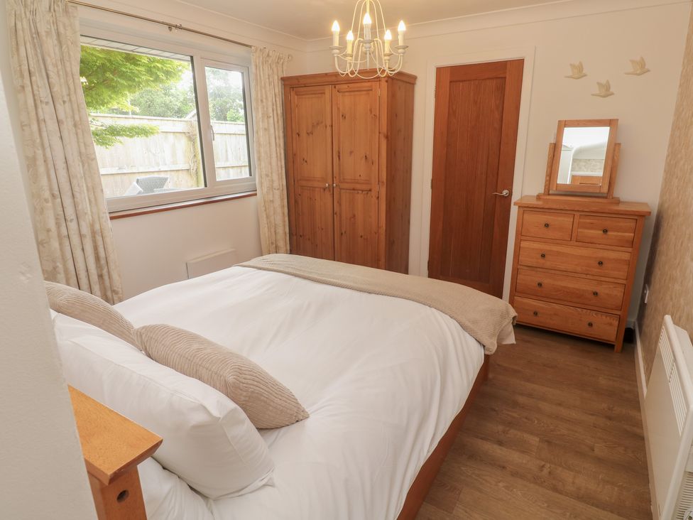 A bedroom with a bed and wooden furniture at Tinners Way in Tresowes near Ashton