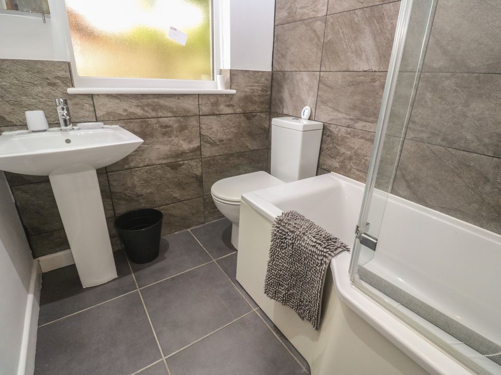 A bathroom with a sink, toilet, bathtub, and towel at Tinners Way in Tresowes near Ashton