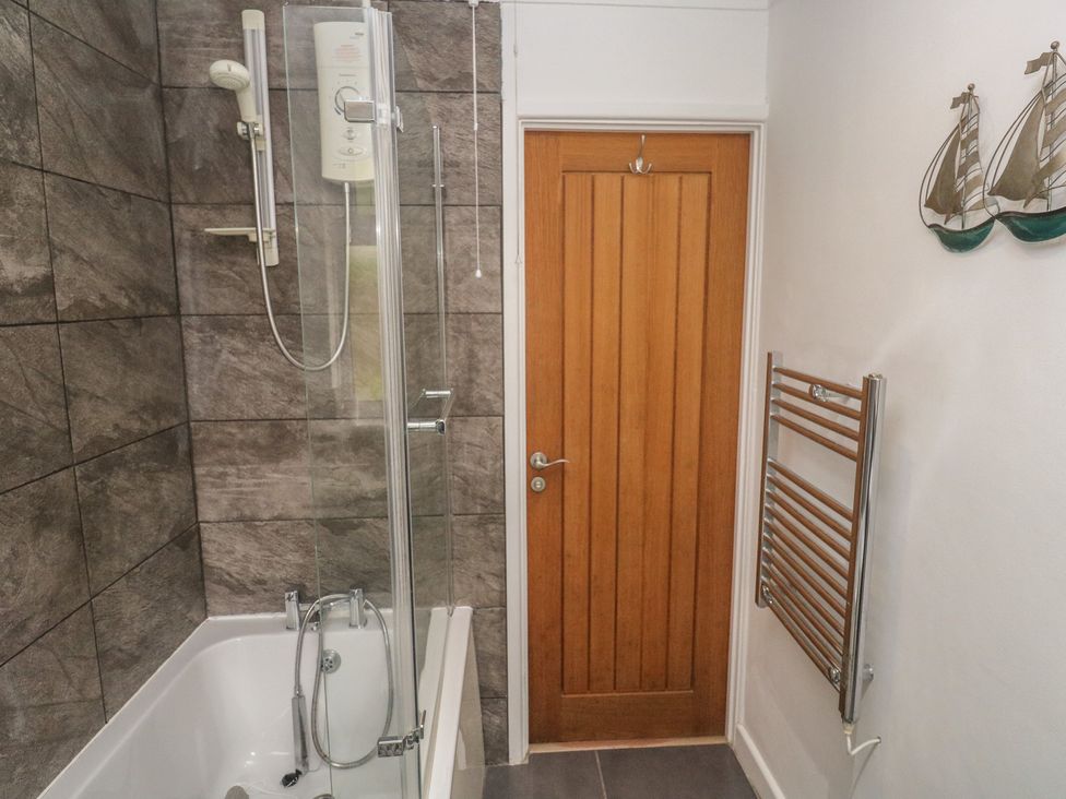 A bathroom with a shower and bathtub at Tinners Way in Tresowes near Ashton