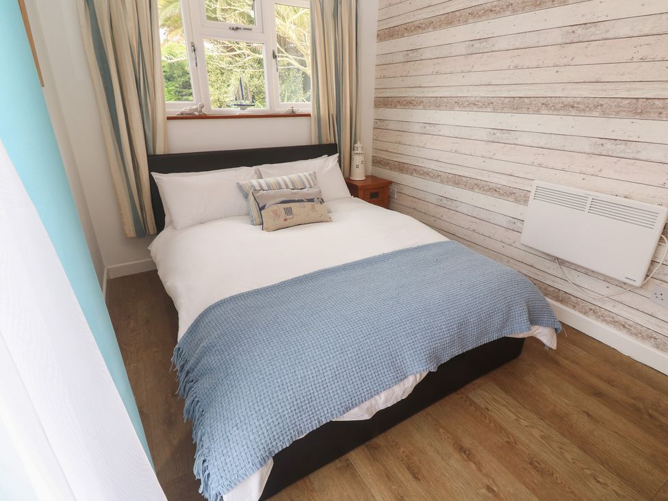A bedroom with a bed and window at Tinners Way Tresowes near Ashton