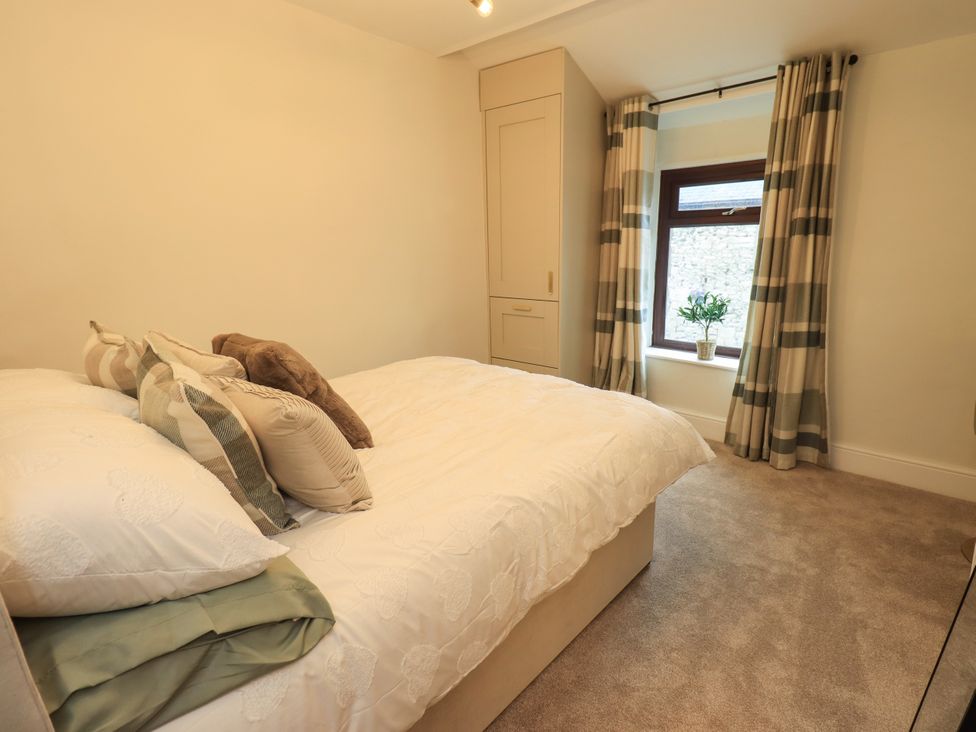 A bedroom with a bed and window at 7 Milnthorpe Road in Holme near Burton-In-Kendal