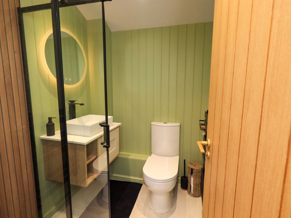 A bathroom with a toilet and sink at 7 Milnthorpe Road in Holme near Burton-In-Kendal