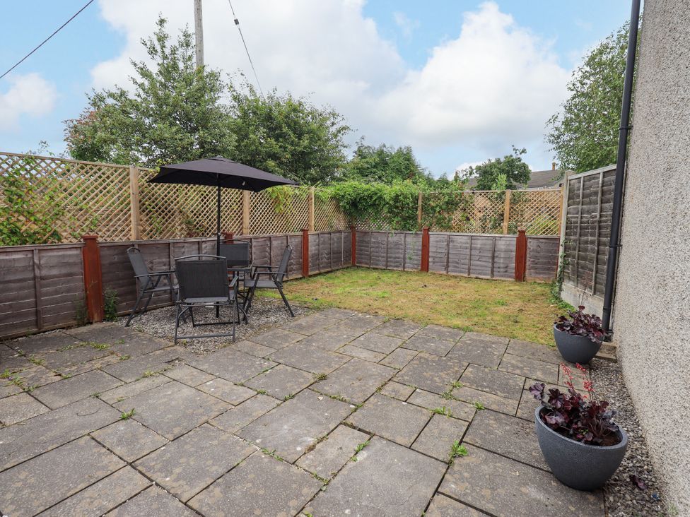 A garden with a patio and furniture at 7 Milnthorpe Road in Holme near Burton-In-Kendal
