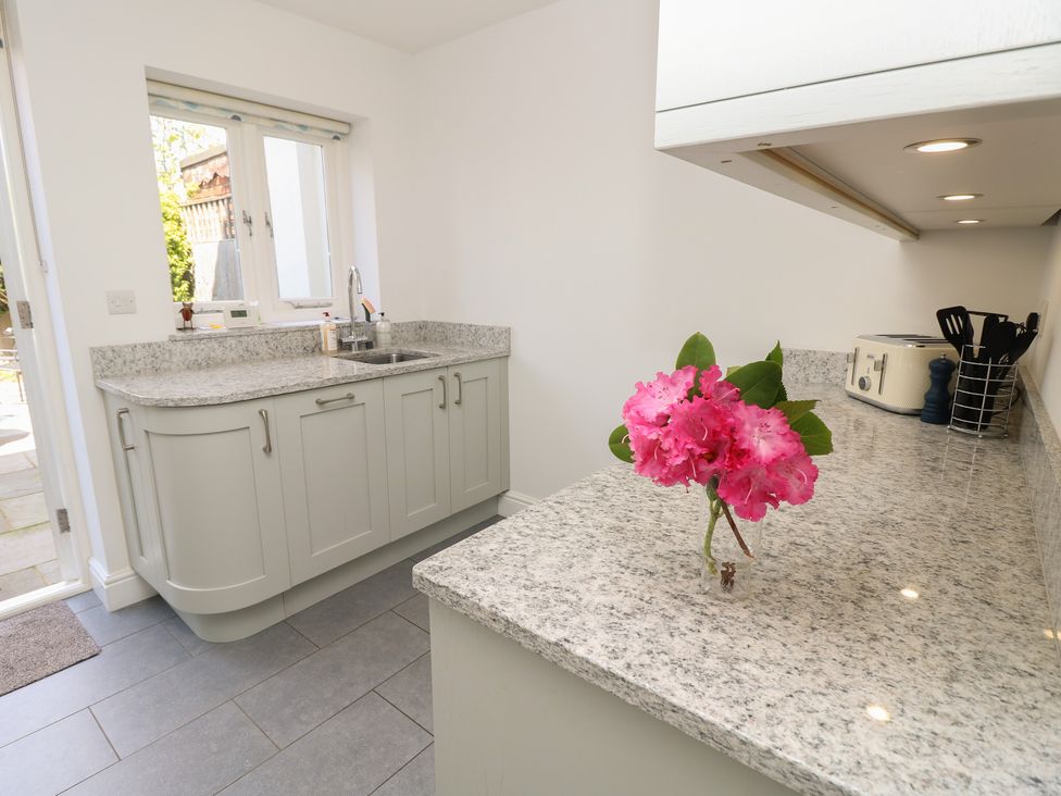 A kitchen with a sink and countertop at Cobblers Cottage in Lymington