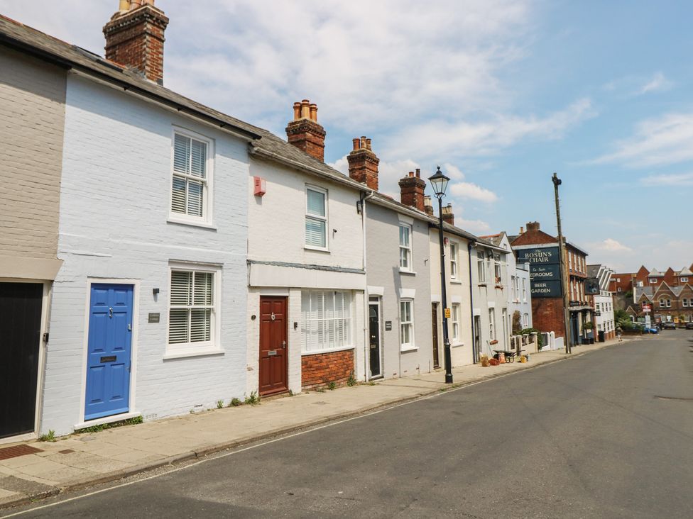 A row of houses with different colored doors on a street at Cobblers Cottage in Lymington