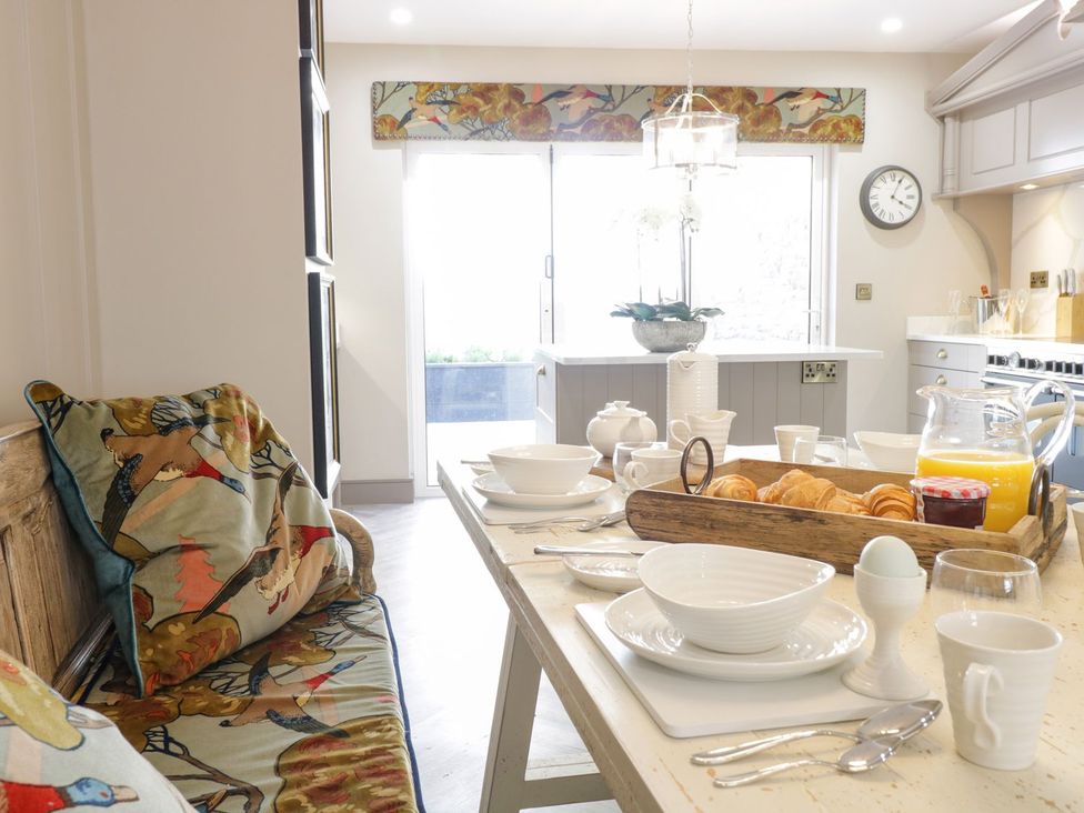 A dining table set with plates and pastries at 2 Llewelyn Street Conwy