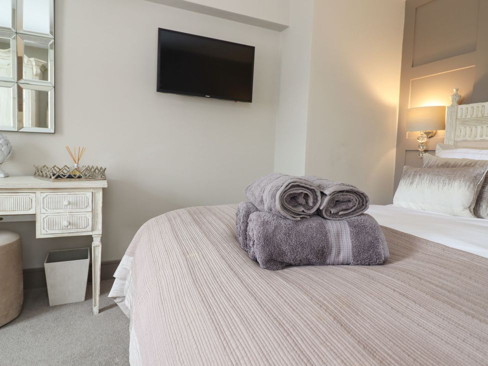 A bedroom with a bed and towels on it at 2 Llewelyn Street in Conwy