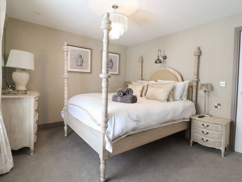 A bedroom with a bed and nightstand at 2 Llewelyn Street in Conwy