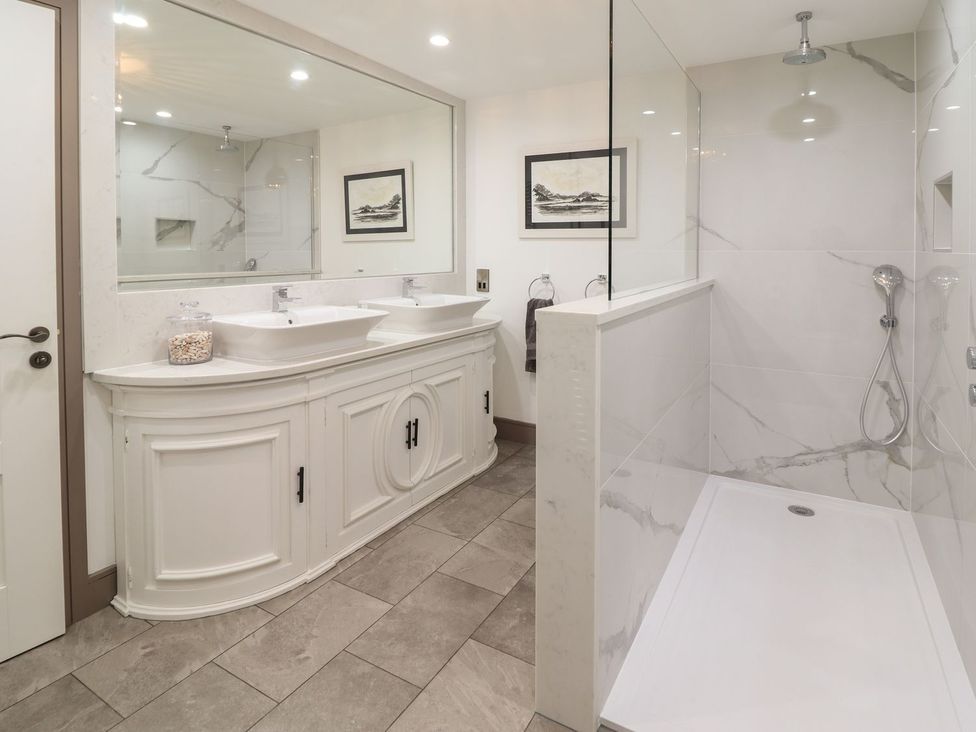 A bathroom with a double sink and shower at 2 Llewelyn Street in Conwy