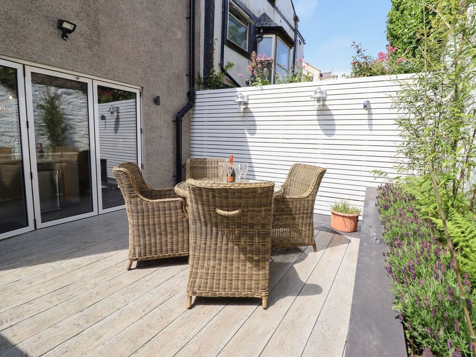 An outdoor seating area with a table and chairs at 2 Llewelyn Street Conwy