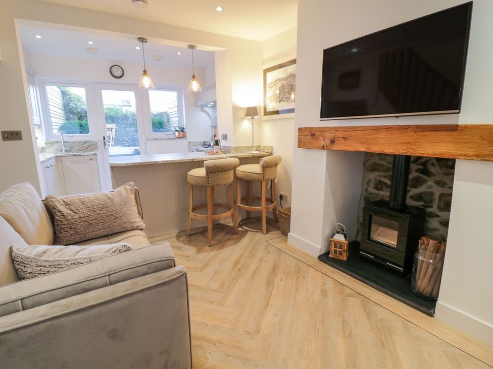 A living room with a sofa and television at 8 Crown Lane in Conwy