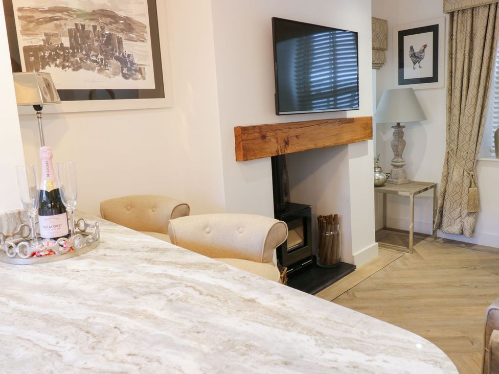A living room with a television and fireplace at 8 Crown Lane in Conwy
