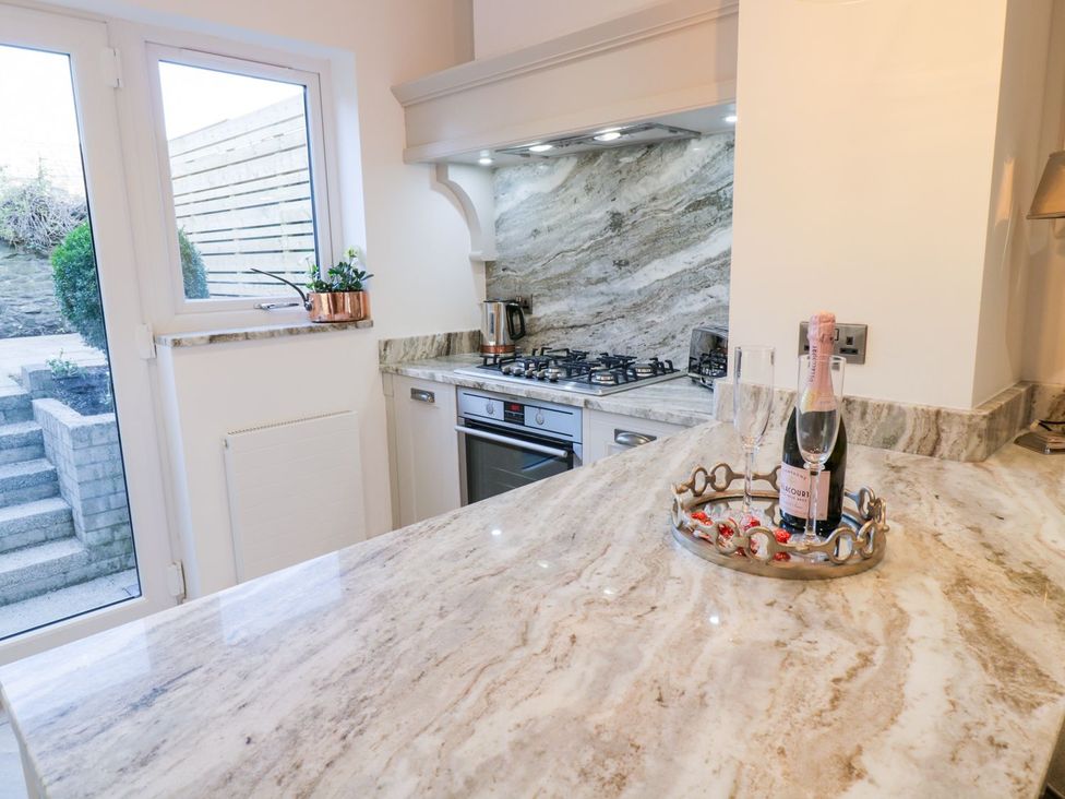 A kitchen with cabinets and a gas stove at 8 Crown Lane Conwy