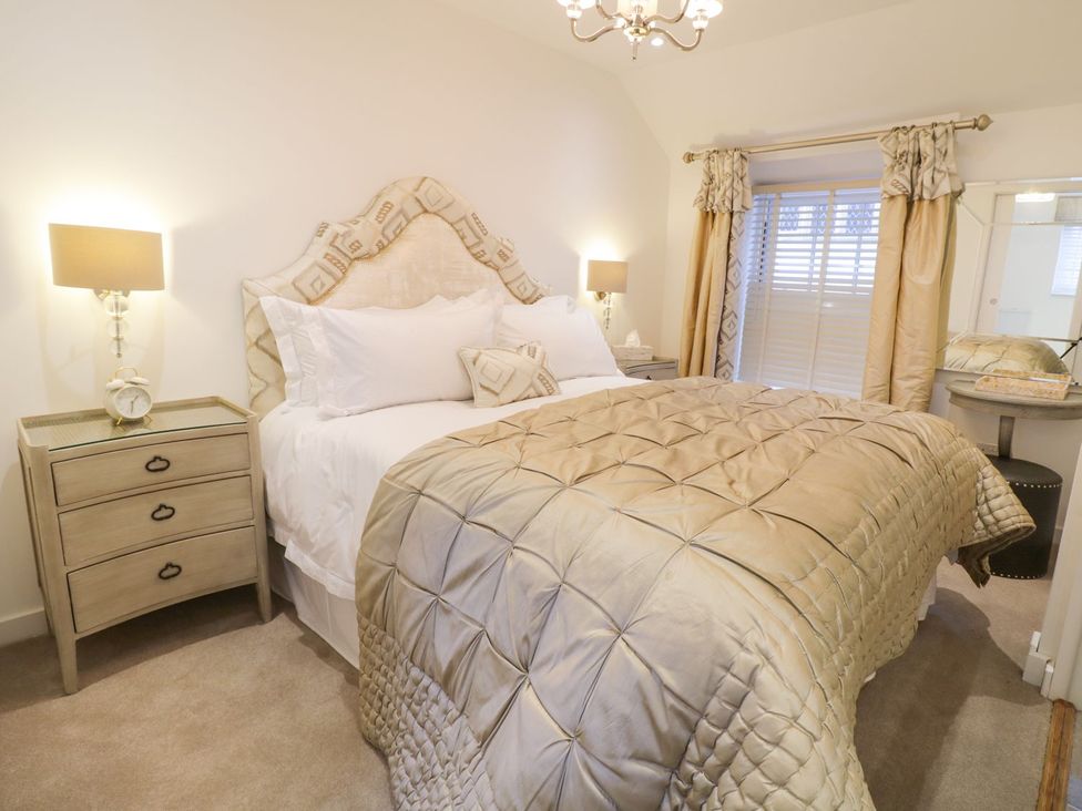 A bedroom with a bed and bedside table at 8 Crown Lane in Conwy