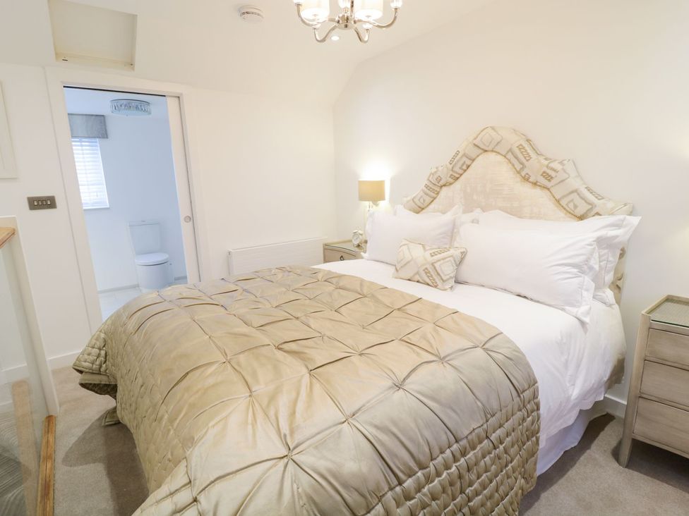 A bedroom with a bed and bedside table at 8 Crown Lane in Conwy