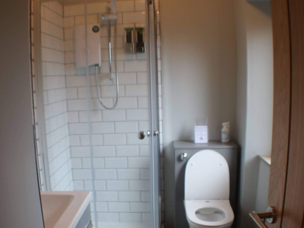 A bathroom with a shower and toilet at Stylish Highland retreat in the heart of town, Pitlochry
