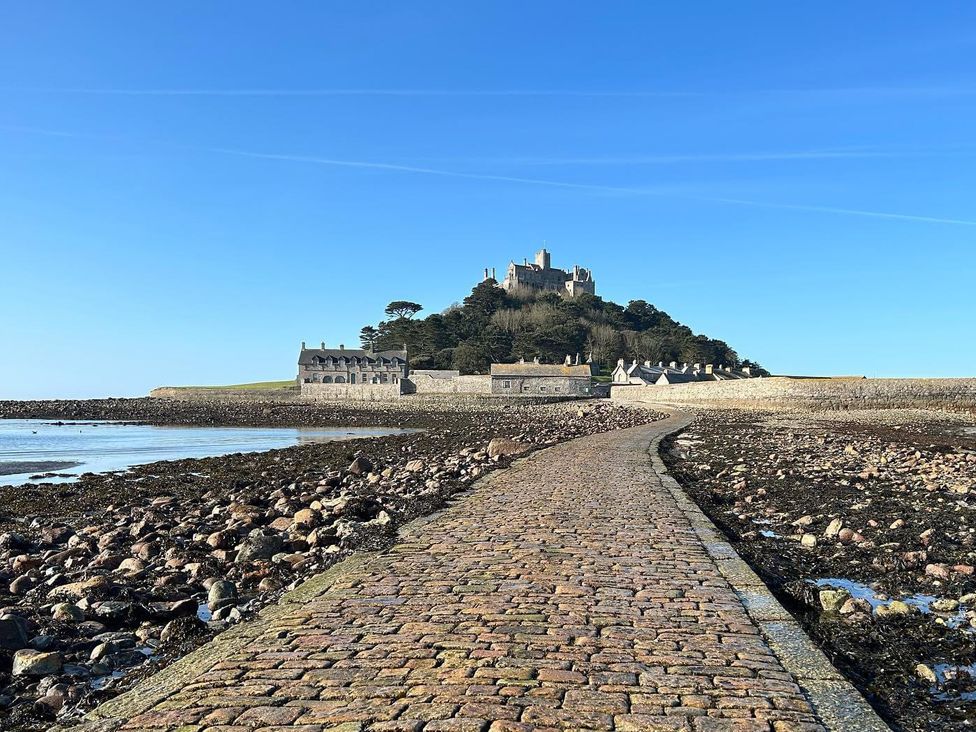 A pathway leading to a castle on a hill at Dog-friendly lodge, steps to St Ives train, Hayle