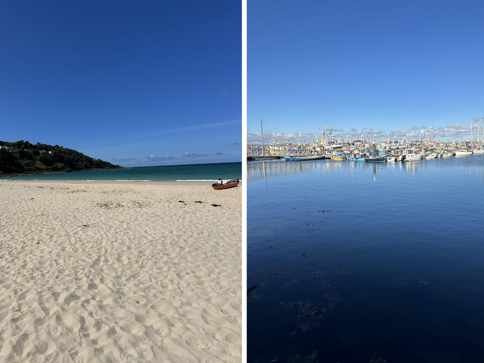 A beach with sand and water beside a harbor with fishing boats at Dog-friendly lodge, steps to St Ives train Hayle
