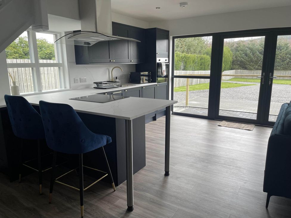 A kitchen featuring an island with chairs at Stylish NC500 base with panoramic views Inverness