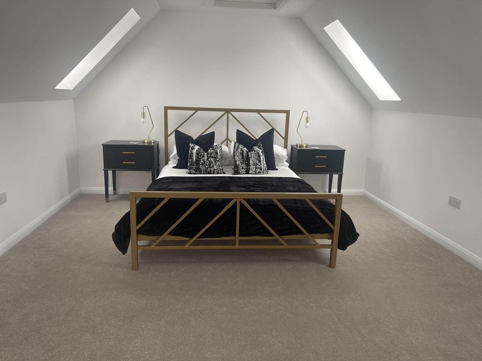 A bedroom with a bed and nightstands at Stylish NC500 base with panoramic views, Inverness