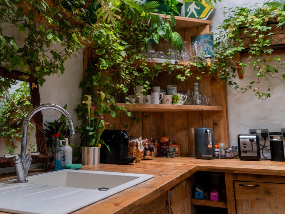 A kitchen with a sink and wooden counter at Hapus Yurt - Two Beautiful Yurts and Barn Cottage