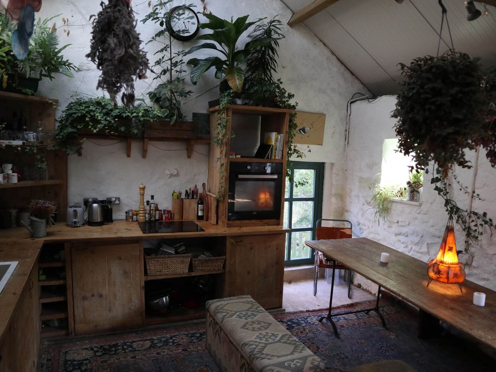 A kitchen with wooden furniture and shelves at Hapus Yurt - Two Beautiful Yurts and Barn Cottage