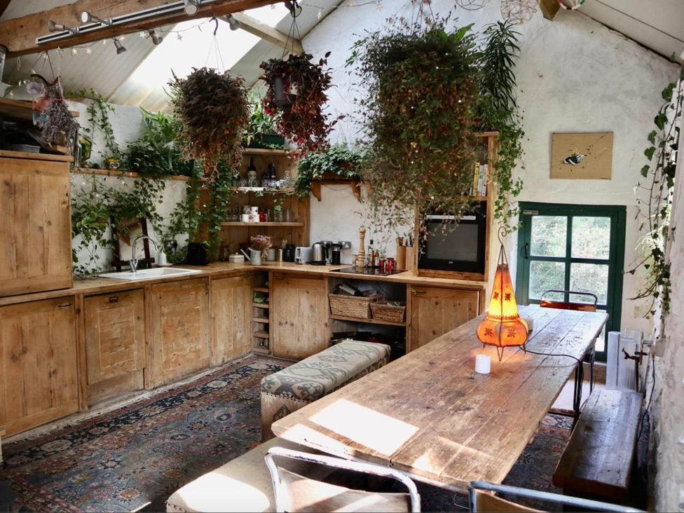 A kitchen with wooden furniture and plants at Hapus Yurt - Two Beautiful Yurts and Barn Cottage 