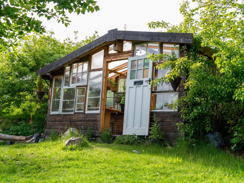 A shed with green surroundings at Hapus Yurt - Two Beautiful Yurts and Barn Cottage