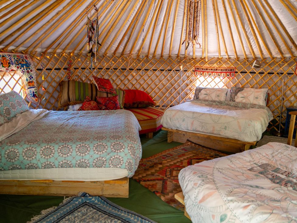 An interior of a yurt with beds and decorative items at Hapus Yurt - Two Beautiful Yurts and Barn Cottage