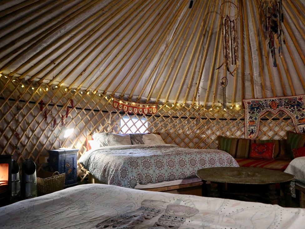 A bedroom with beds and decorative items at Hapus Yurt - Two Beautiful Yurts and Barn Cottage