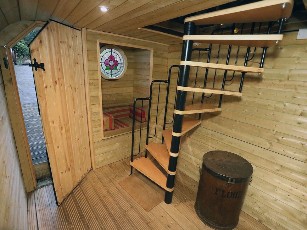 An indoor space with a staircase and wooden walls at Hapus Yurt - Two Beautiful Yurts and Barn Cottage
