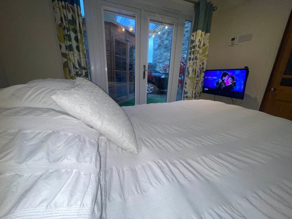 A bedroom with a bed and television at Zip Cottage Sleeps 2-3 climb snowdon zip world