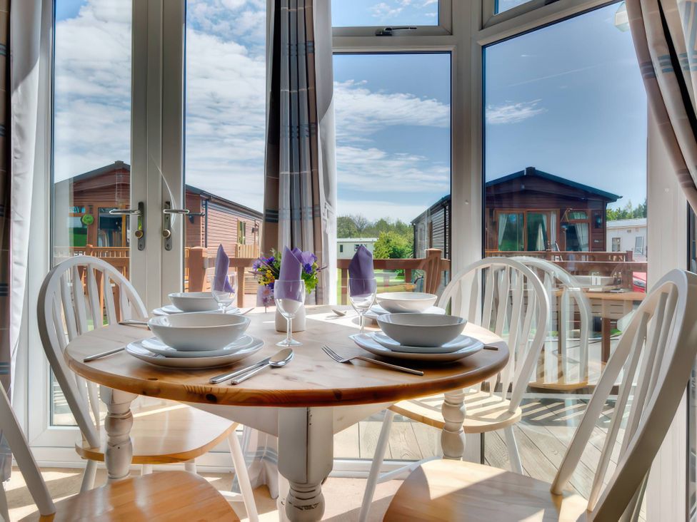 A dining table set for a meal at Pet-friendly lodge with hot tub near the coast