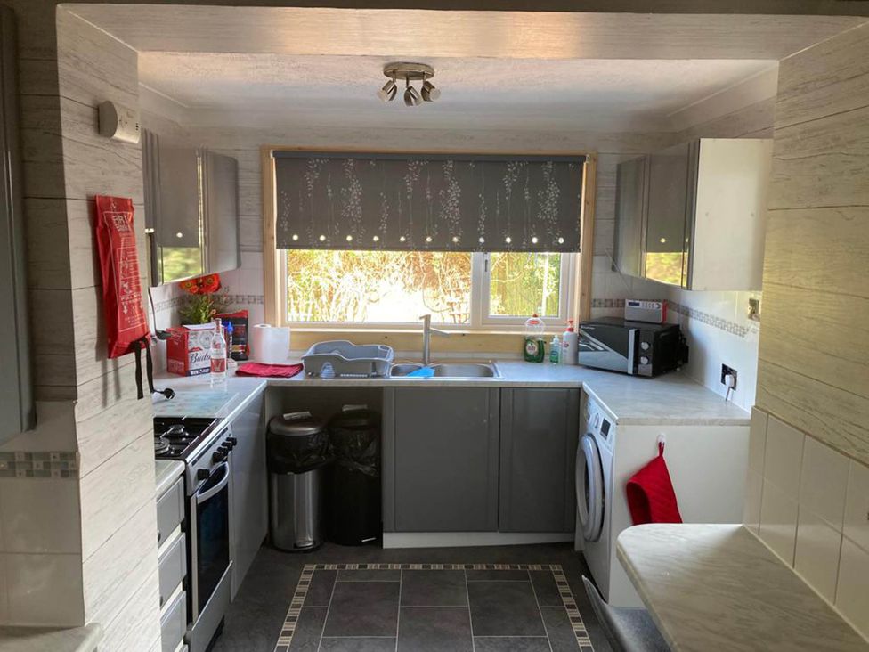 A kitchen with sink and appliances at Spacious family base with garden near Loch Ness